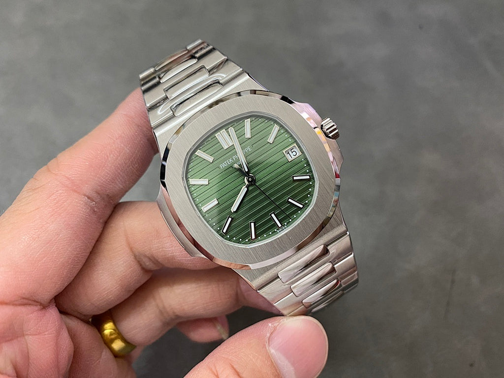 Wristwatch with green dial, baton markers, and date window at 15 on steel case