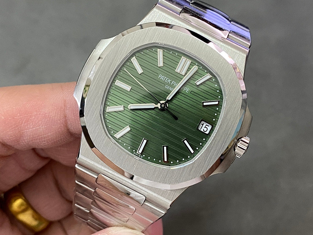 Wristwatch front view with green dial, baton hands, and date window at 15