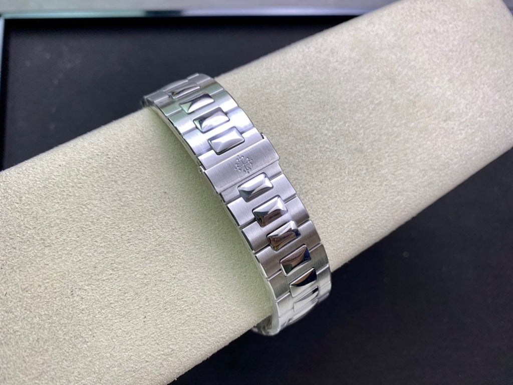 Stainless steel watch bracelet on wrist, featuring polished and brushed link segments