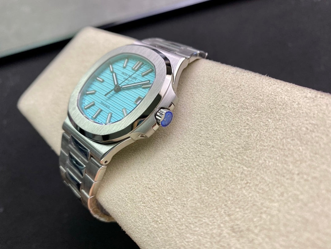 Stainless steel wristwatch with bright blue dial and metal bracelet, angled side view