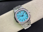Stainless steel wristwatch with bright blue dial, baton hands, and date window, close front
