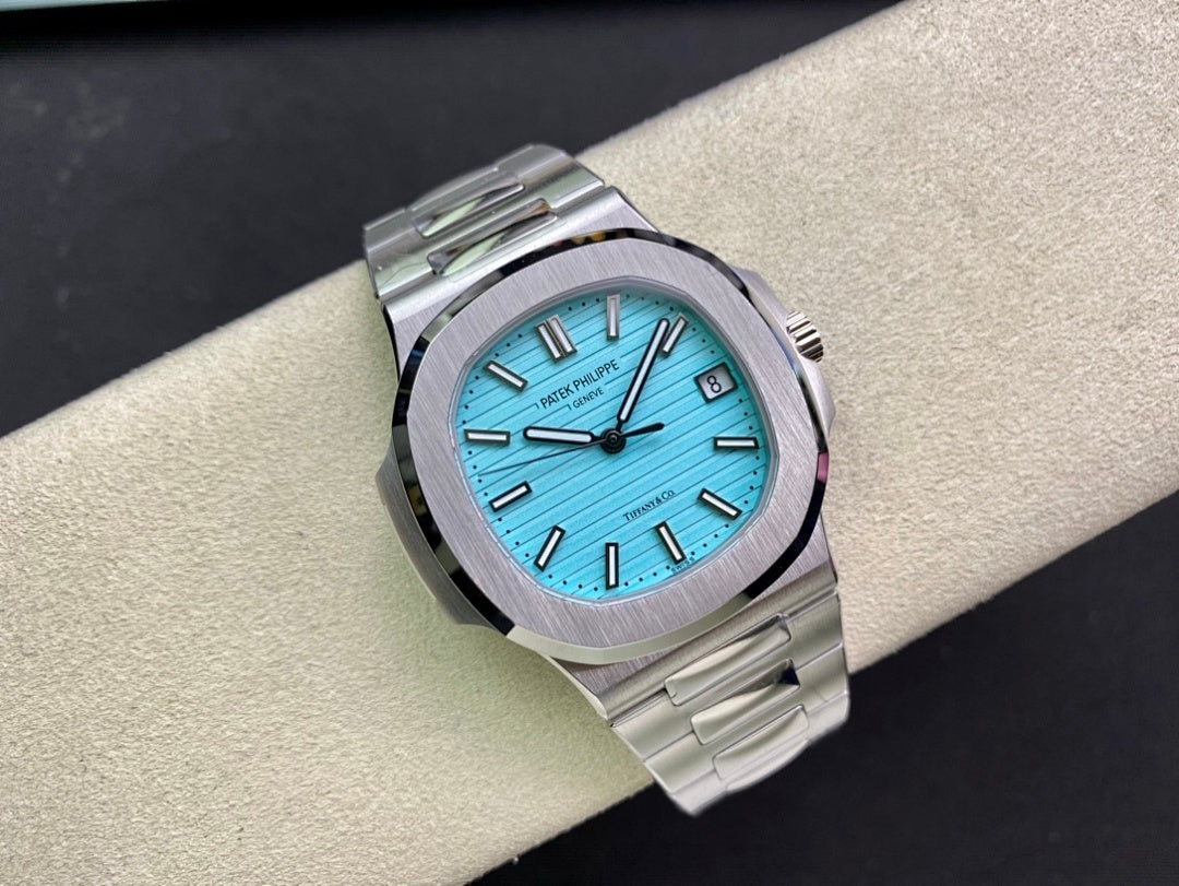 Stainless steel wristwatch with bright blue dial, baton hands, and date window, close front