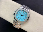 Stainless steel wristwatch with bright blue dial and polished bezel, angled view on wrist