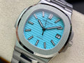 Stainless steel wristwatch with bright blue dial and metal link bracelet, close-up view
