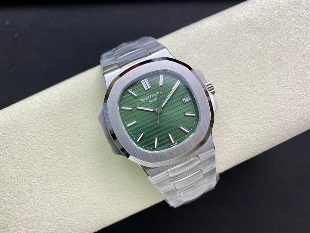 Patek Philippe watch with green dial, silver bezel, and metal bracelet, three-quarter view