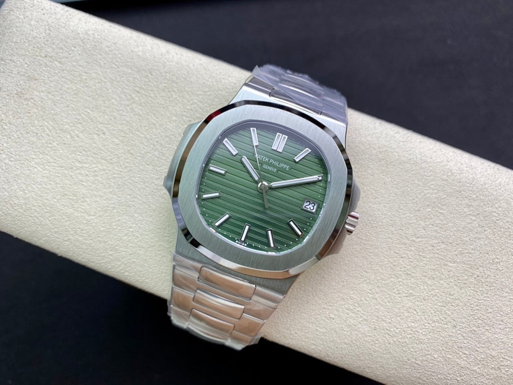 Patek Philippe watch with green dial, silver bezel, and metal bracelet, angled view
