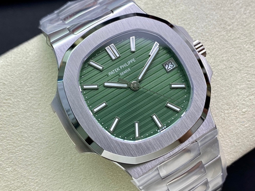 Patek Philippe watch with green dial, silver bezel, and metal bracelet, face close-up