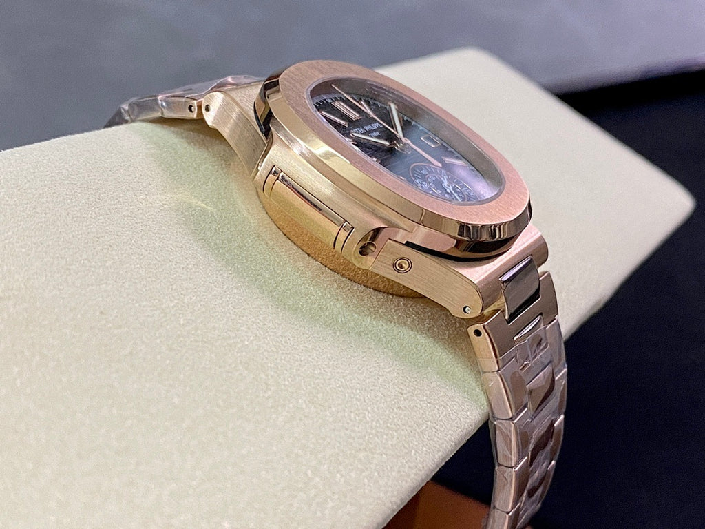 Rose-gold wristwatch profile with crown guards and blue dial glimpsed