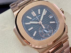 Close-up rose-gold wristwatch with blue dial, baton markers, subdials, and date