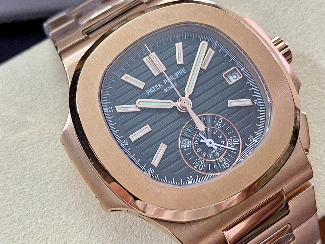 Close-up rose-gold wristwatch with blue dial, baton markers, subdials, and date