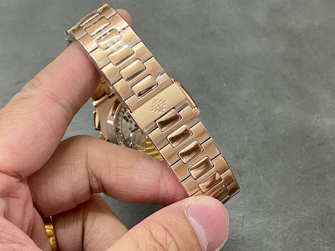Patek Philippe watch side view with rose-gold tone metal link bracelet