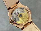 Open rose-gold watch caseback showing mechanical movement under glass