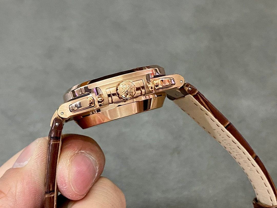 Rose-gold watch case with crown and brown leather strap, side view