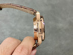 Rose-gold watch case with brown leather strap and clasp, side profile close-up