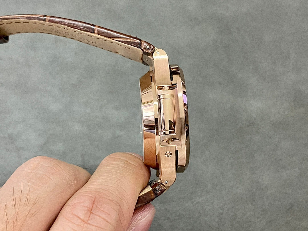 Rose-gold watch case with brown leather strap and clasp, side profile close-up