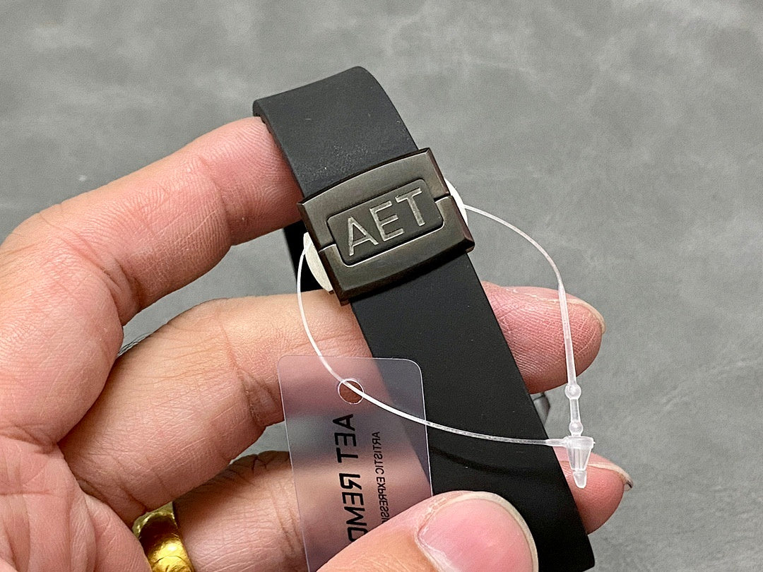 Black rubber strap with deployment buckle and small connector on the band