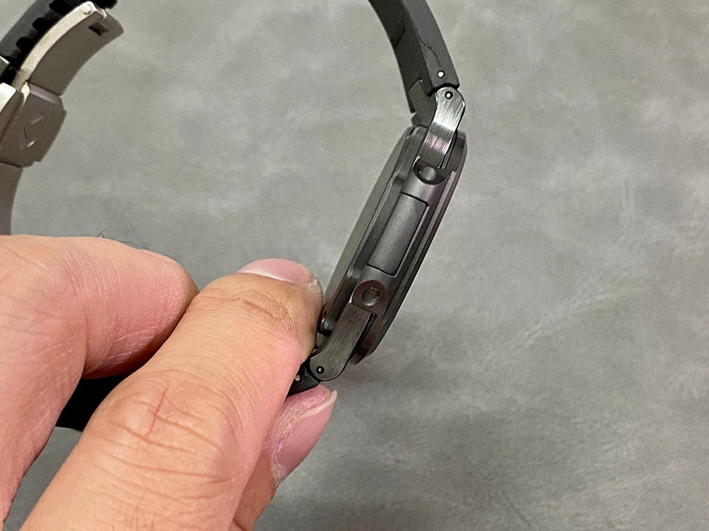 Metal link bracelet with black case side, held by the band end