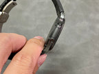 Metal link bracelet with black case side, held by the band end