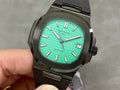 Black sport wristwatch with turquoise dial, baton markers, and date window at 3 o’clock