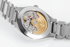 Stainless steel watch case with visible gold-toned movement through window