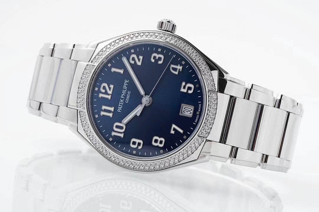 Stainless steel wristwatch with blue dial, jeweled bezel, and metal bracelet