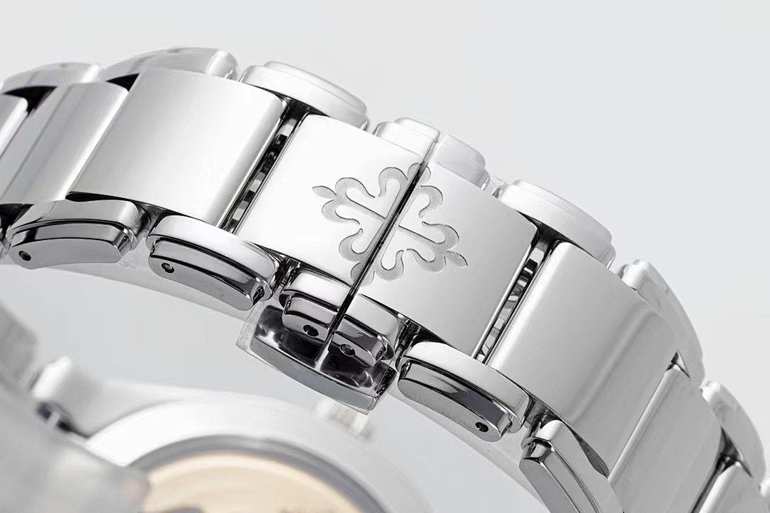 Steel watch bracelet with engraved links and part of diamond bezel around dark face