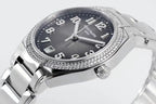 Diamond bezel steel wristwatch with black dial, large Arabic numerals, crown at 3 o'clock