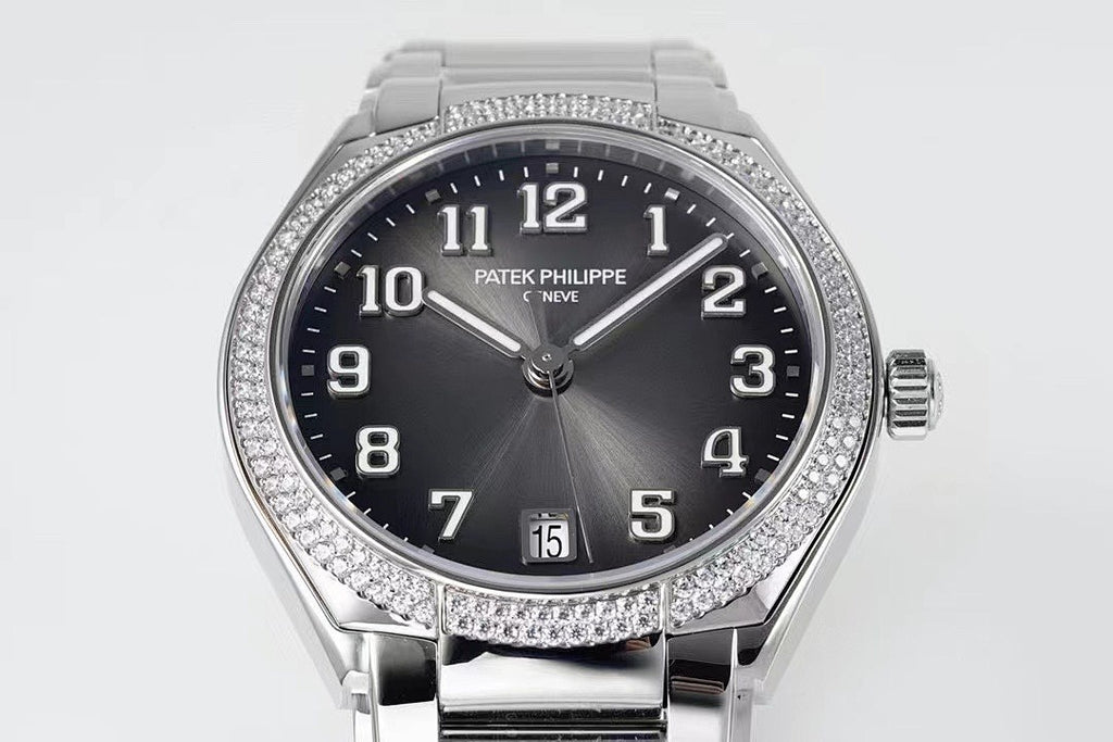 Diamond bezel steel wristwatch with dark dial, date window, and crown at 3 o'clock