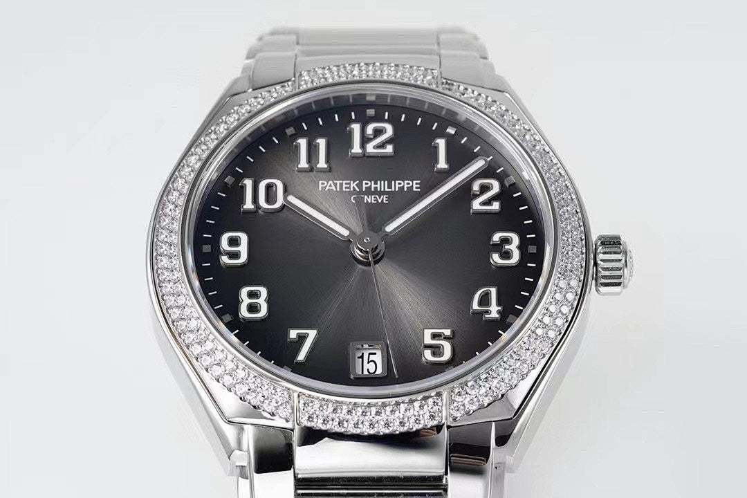 Diamond bezel steel wristwatch with dark dial, date window, and crown at 3 o'clock