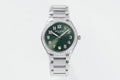 Men's steel wristwatch with green dial, diamond bezel, and link bracelet