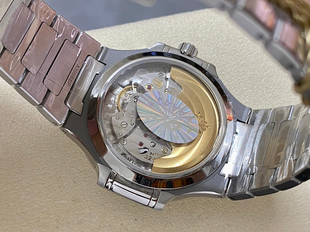 Stainless steel watch with open caseback showing gold-toned movement