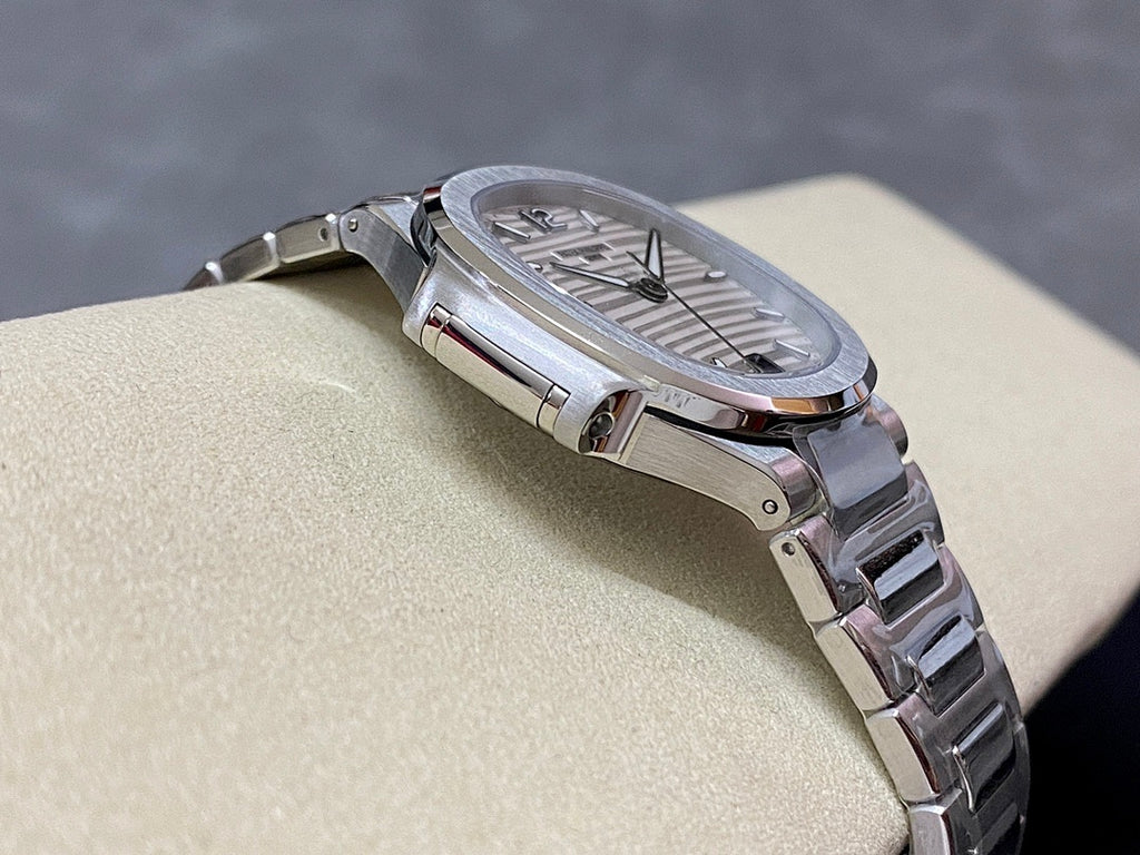 Stainless steel wristwatch with silver dial and textured bezel