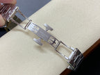 Steel watch bracelet with engraved links and clasp on light background