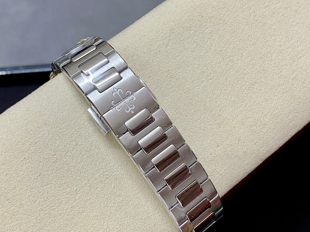 Metal watch bracelet with polished links and engraved center panel