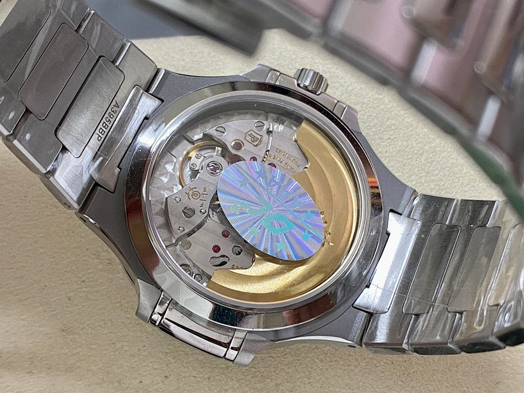 Steel wristwatch with open caseback showing mechanical movement and iridescent rotor