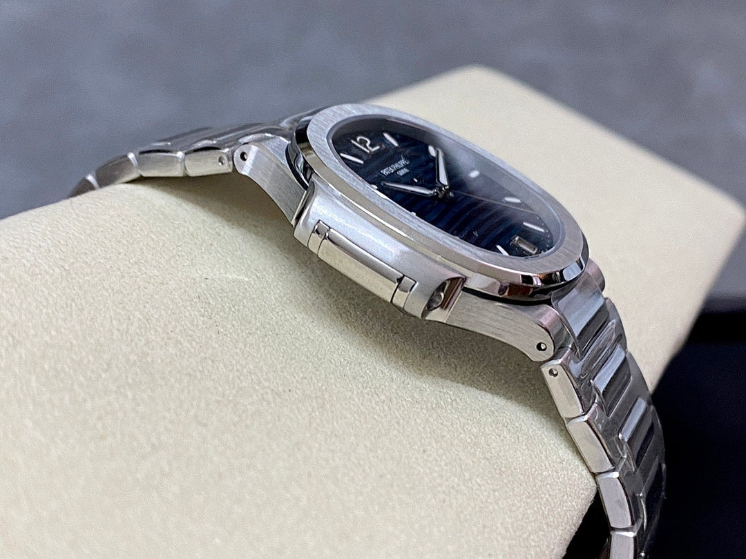Steel wristwatch case and bracelet with blue dial and crown detail