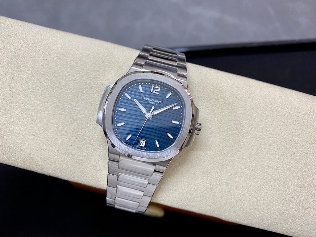Blue dial steel wristwatch on bracelet with baton hour markers and seconds hand