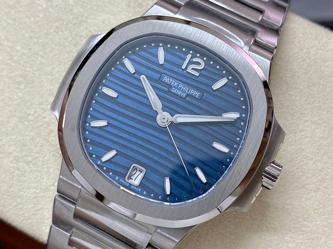 Patek Philippe steel wristwatch with blue dial, silver hands, and date window