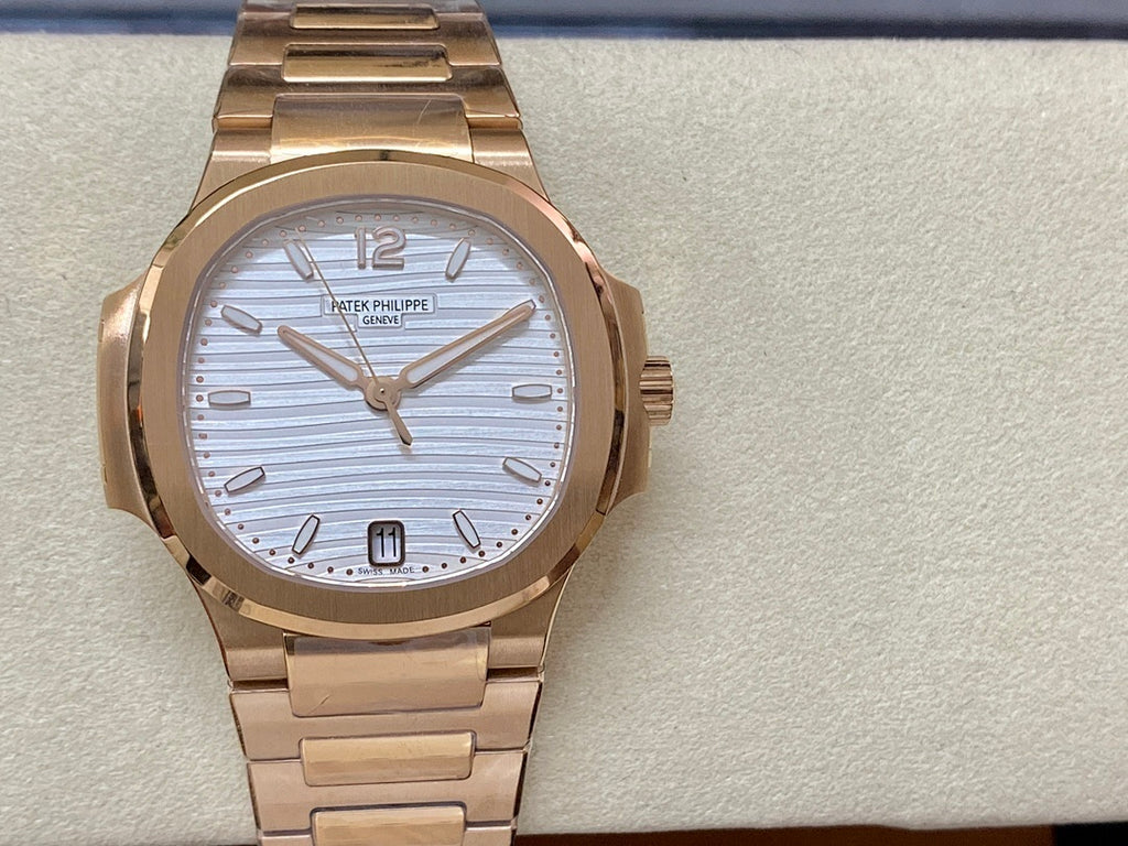 Patek Philippe wristwatch on band with gold-tone links and light blue striped face, large indices