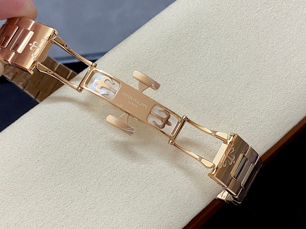 Patek Philippe wristwatch clasp and links in gold-tone metal, open bracelet view