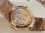 Patek Philippe wristwatch with gold-tone case back and visible mechanical movement, on bracelet