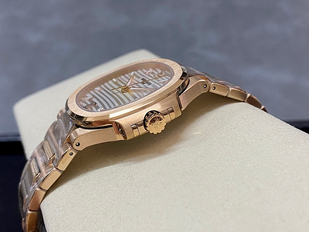 Patek Philippe wristwatch with gold-tone case and bracelet, textured bezel and side crown