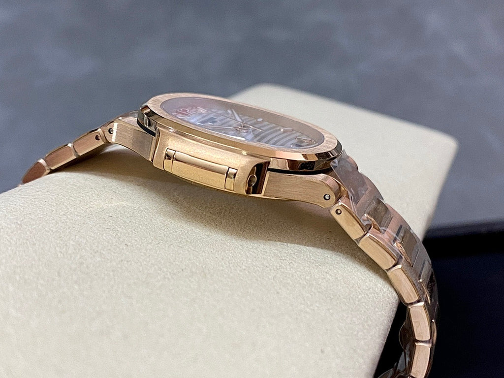 Patek Philippe wristwatch on bracelet with gold-tone clasp and round case profile