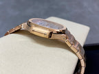 Patek Philippe wristwatch on bracelet with gold-tone clasp and round case profile