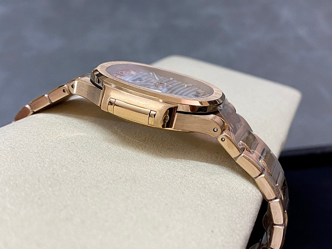 Patek Philippe wristwatch on bracelet with gold-tone clasp and round case profile