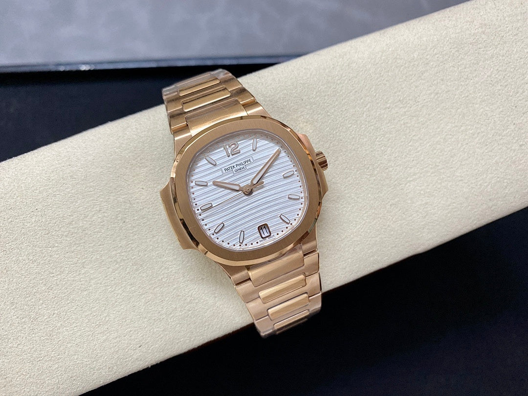Patek Philippe wristwatch with gold-tone bracelet and light blue striped dial, minimalist hands