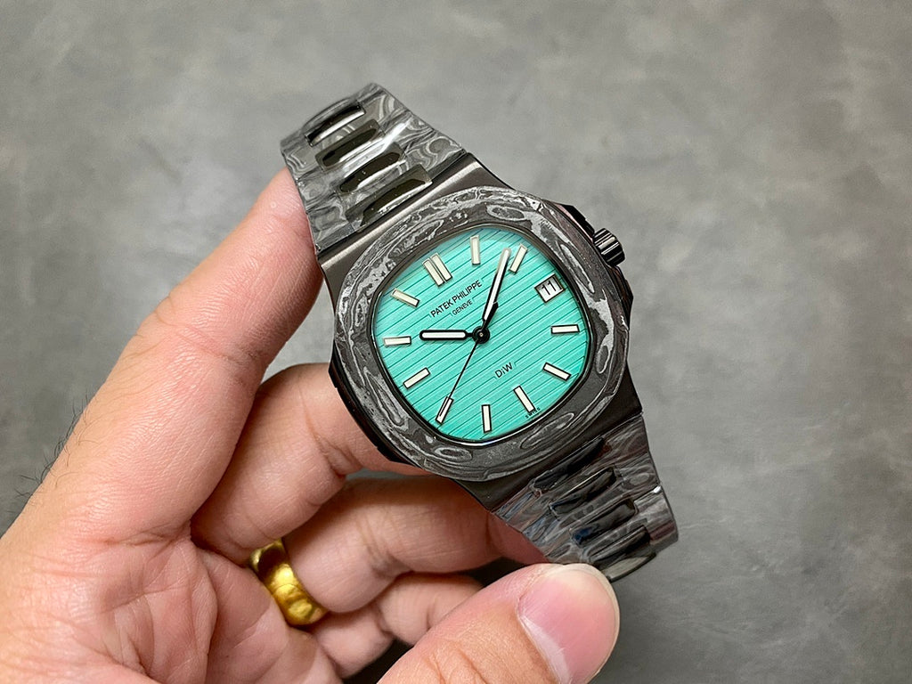 Patek Philippe watch front turquoise dial black textured case metal bracelet