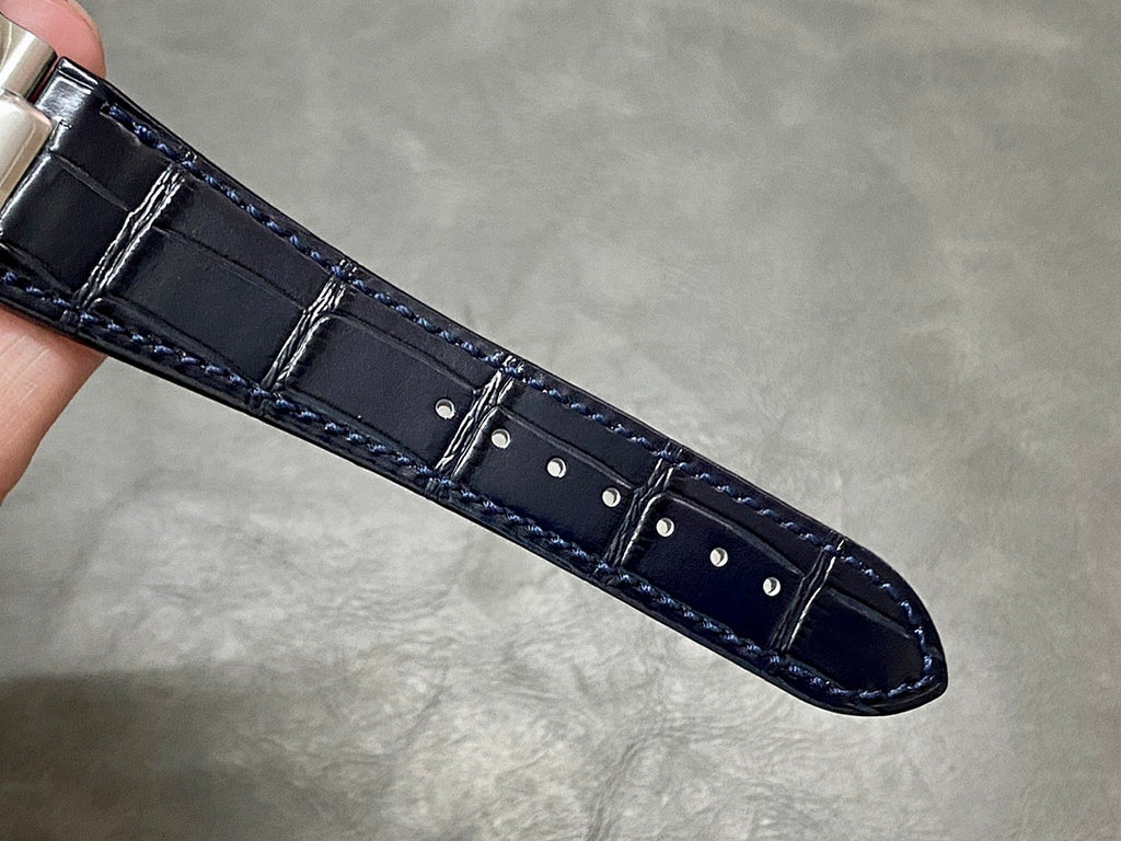 Dark blue leather watch strap with stitched edges and stitched buckle tab