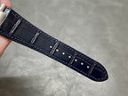 Dark blue leather watch strap with stitched edges and stitched buckle tab