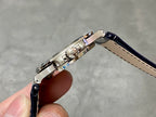 Patek Philippe watch with metal case and dark blue leather strap
